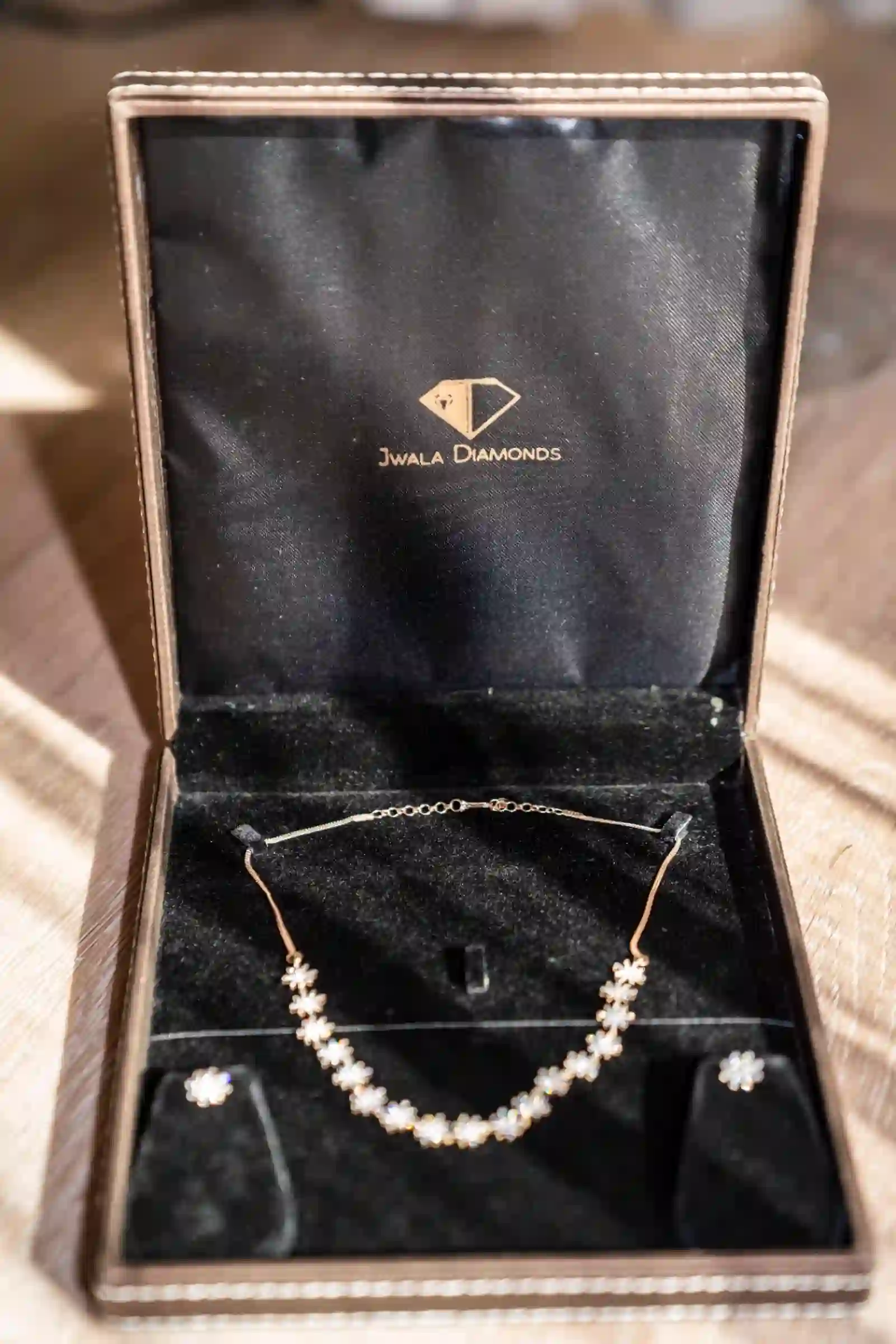 Bridal diamond necklace and earring set displayed in a Jwala Diamonds keepsake box