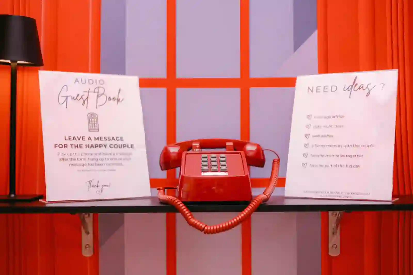 Vintage red rotary phone audio guest book signage inside the telephone booth