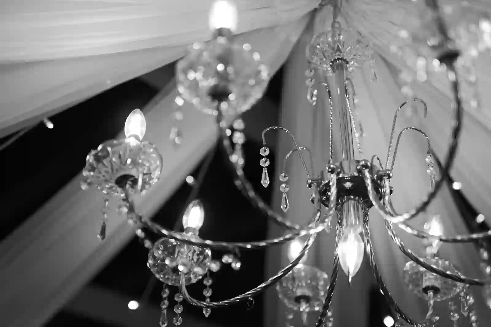 Black and white close-up of layered crystal chandeliers