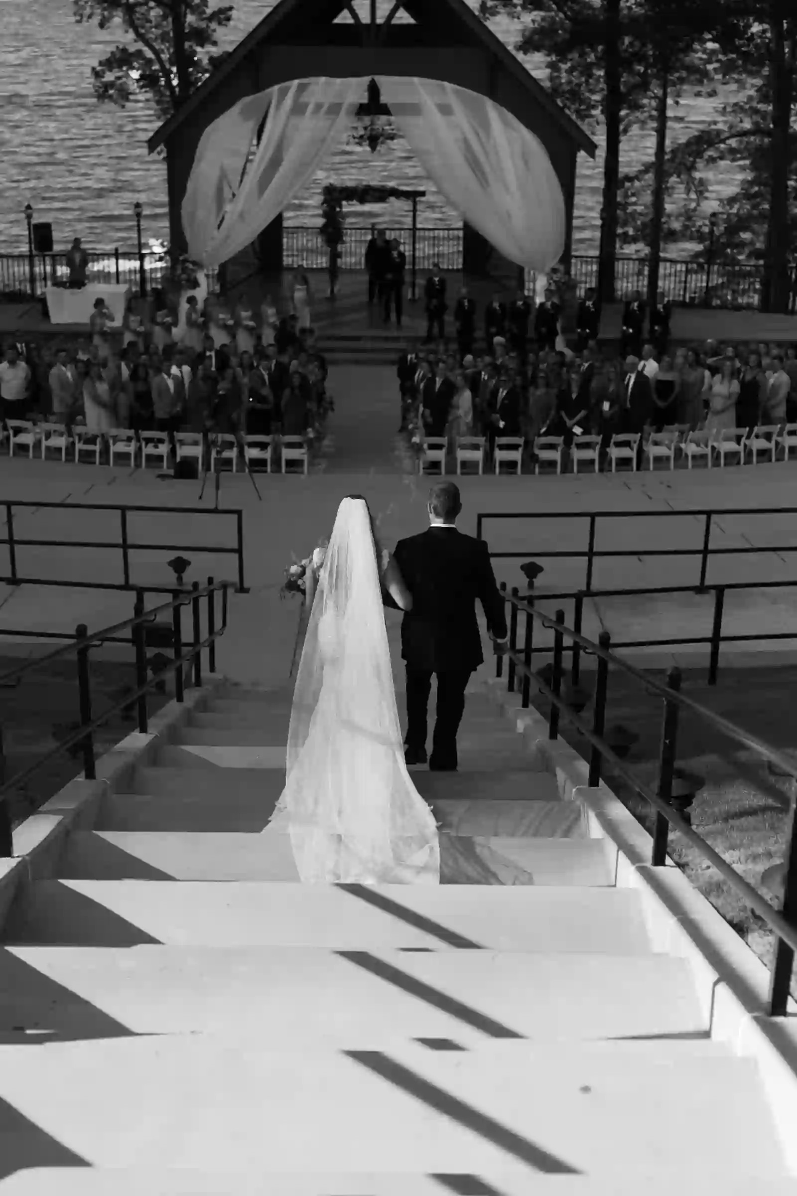 Black and white processional down the lakeside ceremony steps