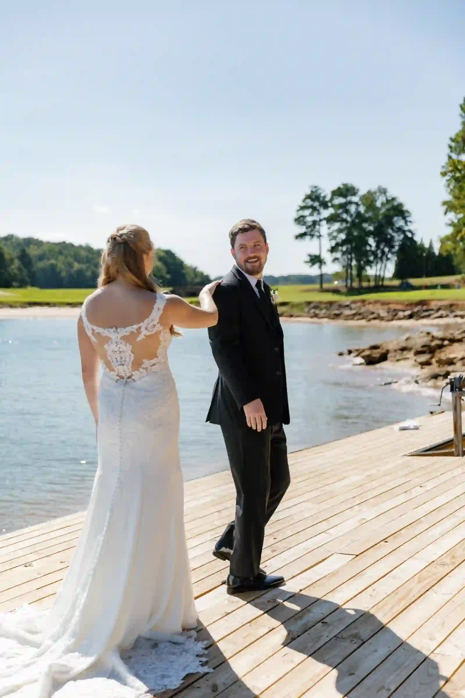 Groom turning to see his bride for the first time on the dock