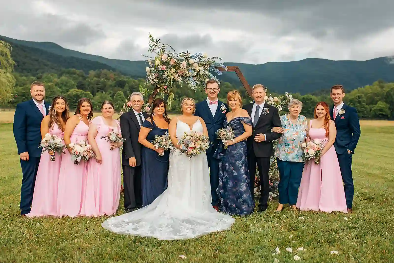 Family portrait in front of the floral ceremony arch