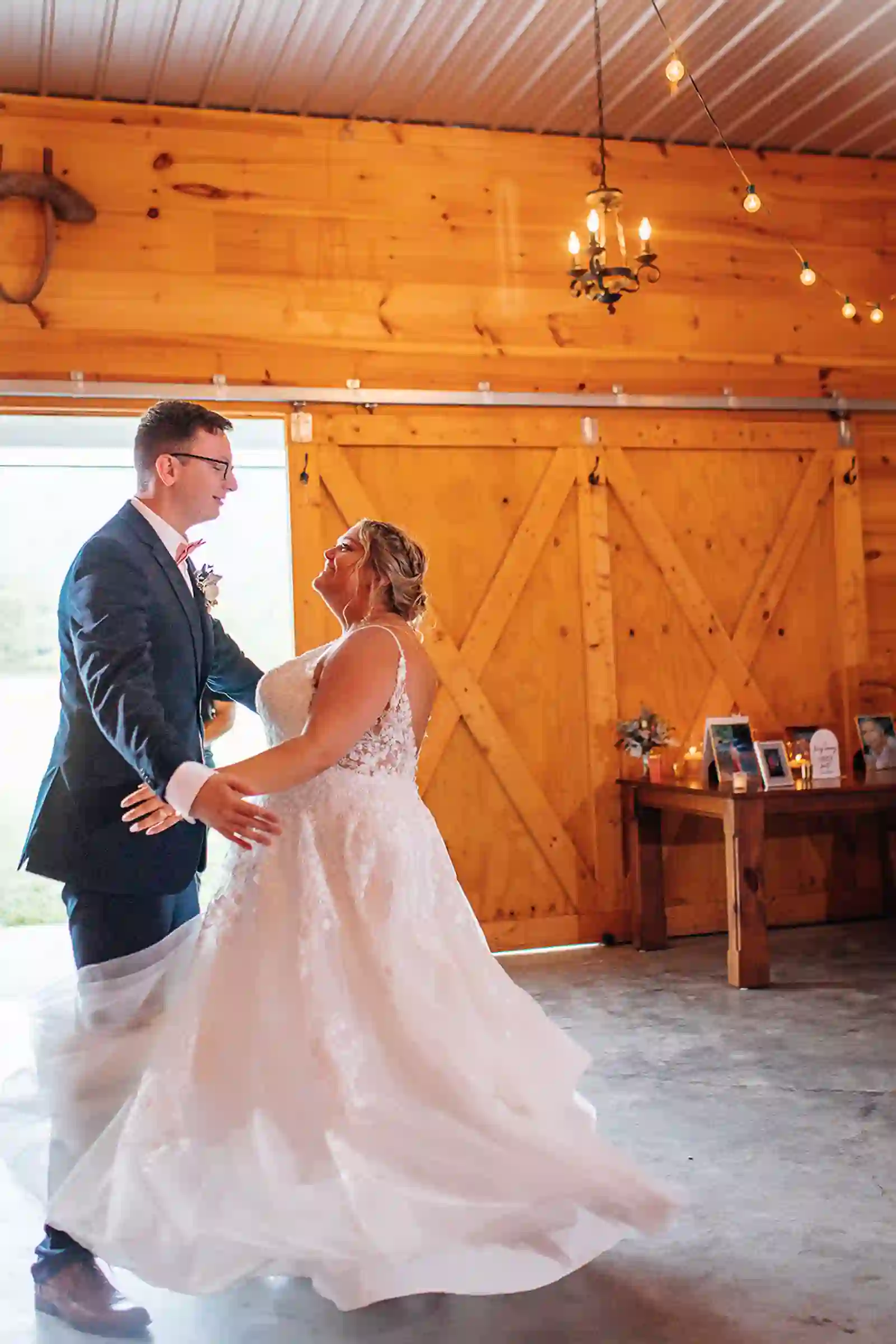 Bride and groom sharing a dance inside the barn reception space