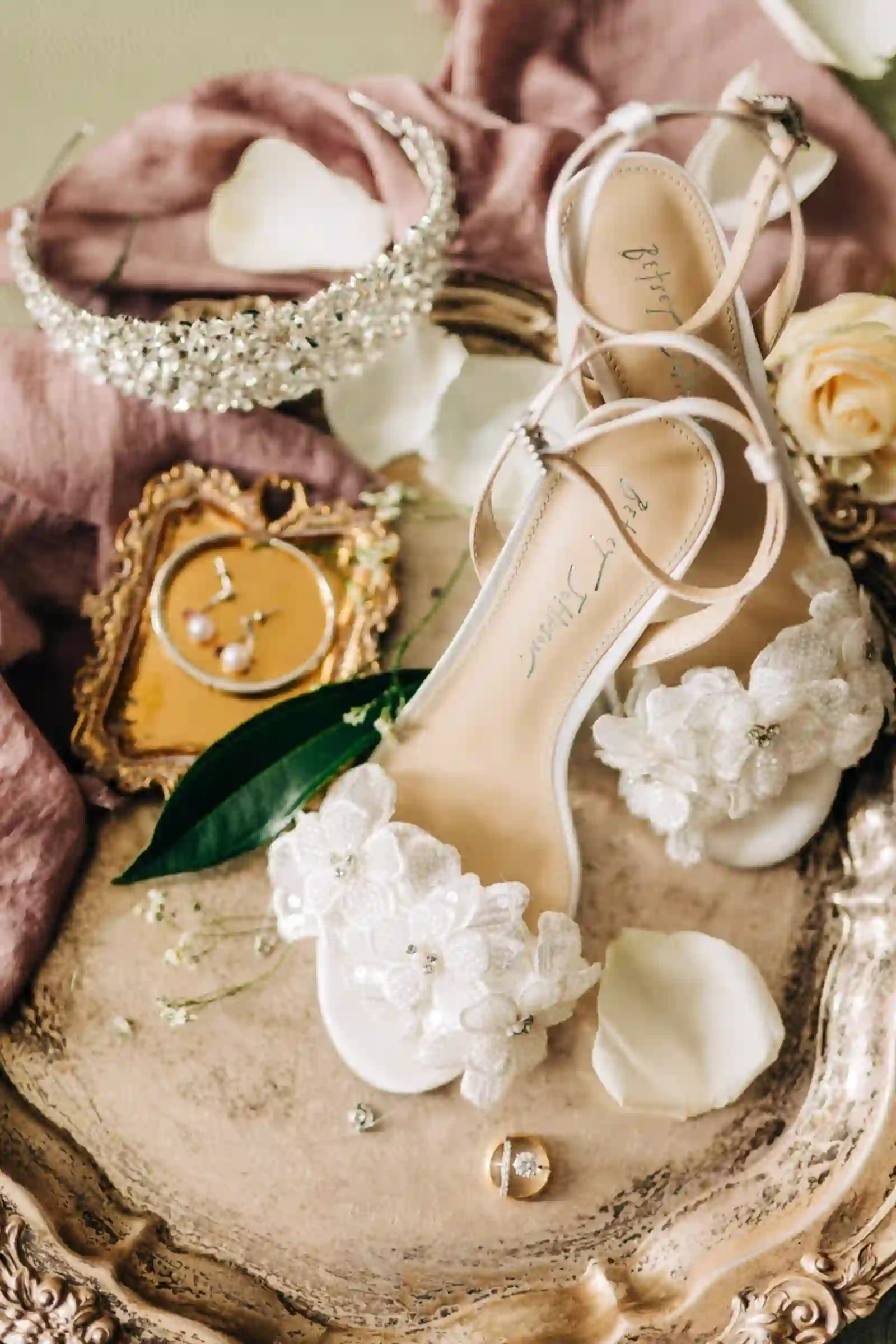 Bridal shoes and accessories styled on an ornate tray