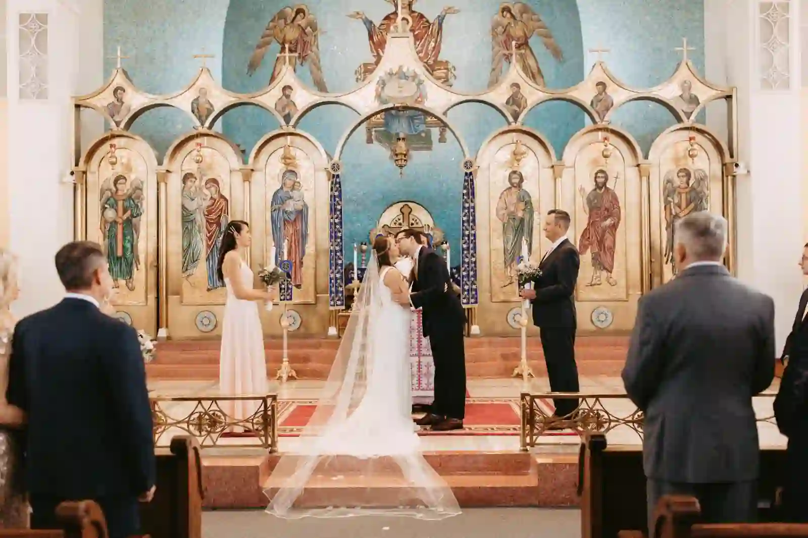 First kiss beneath the gold mosaic iconostasis