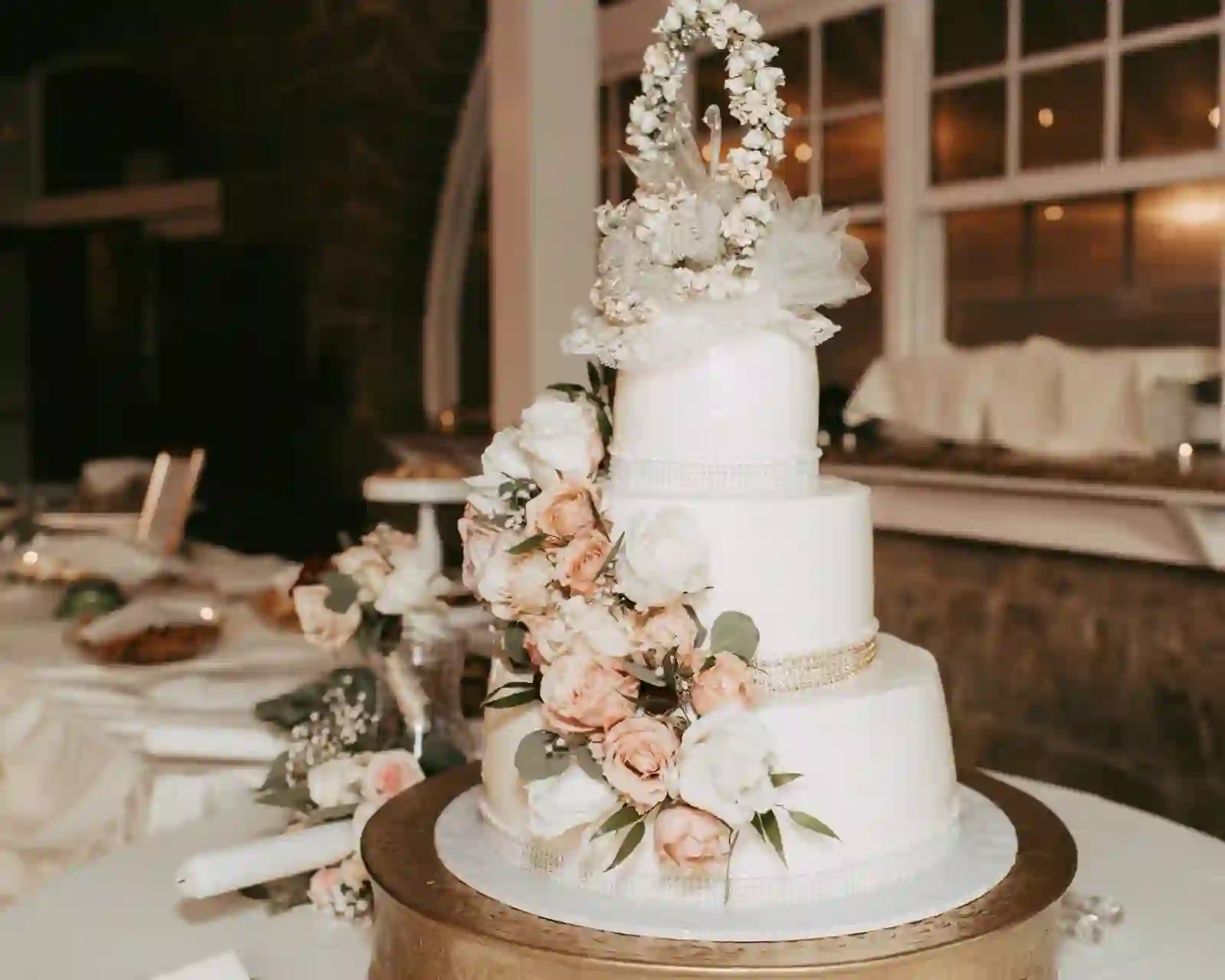 Tiered wedding cake with cascading roses