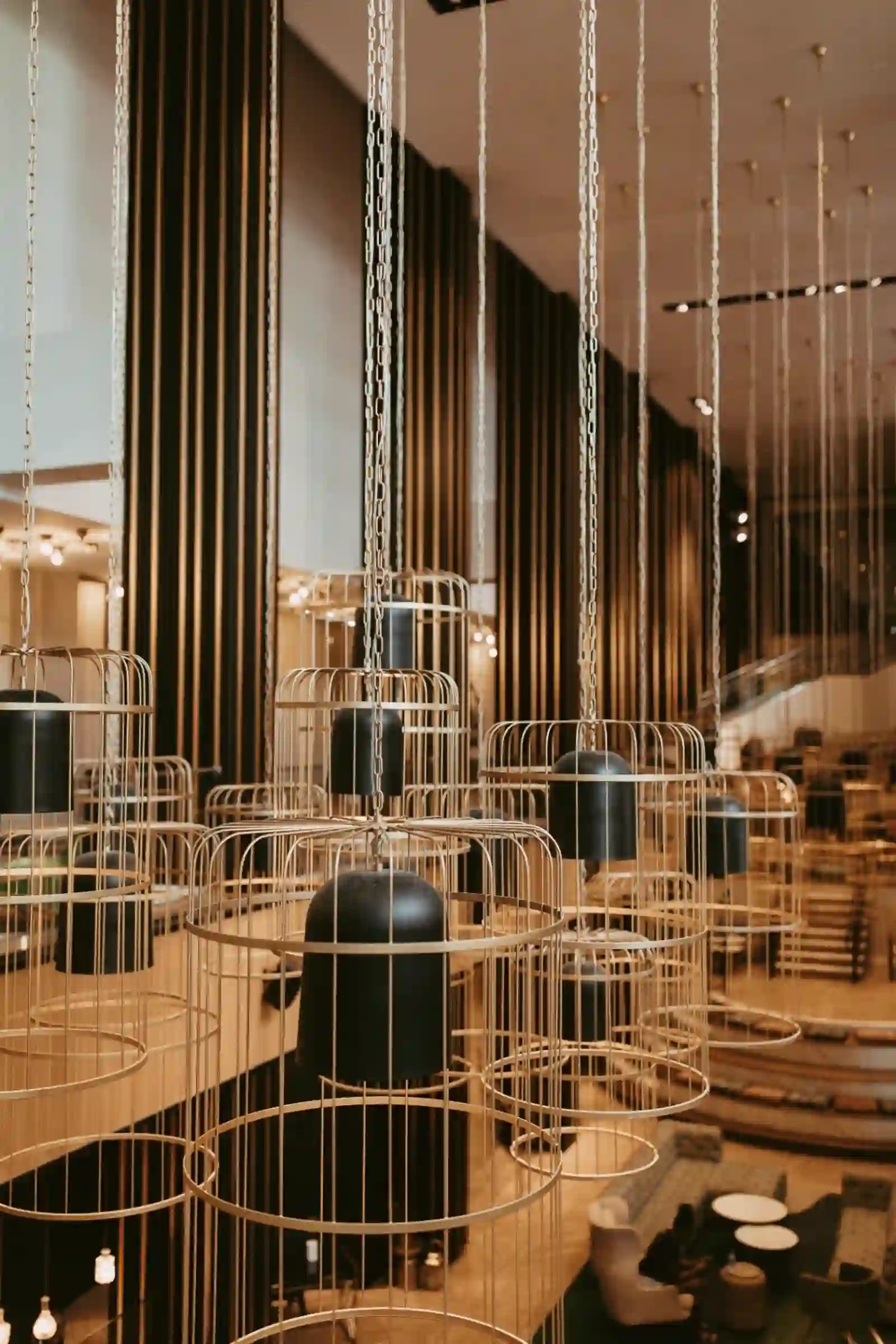 Architectural pendant chandeliers in a sculptural reception space