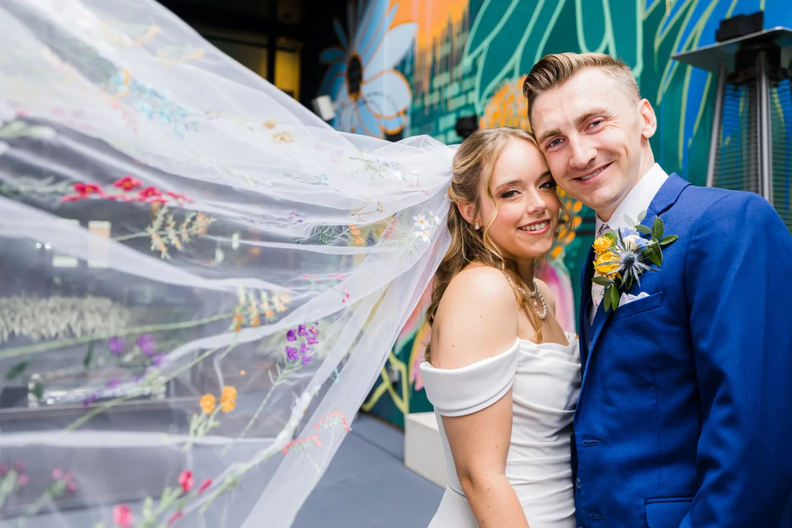 Bride and groom with embroidered floral veil