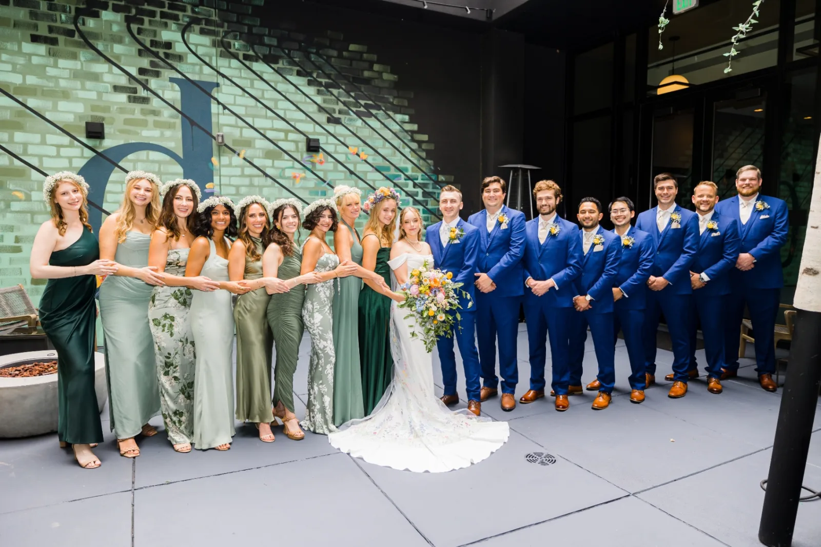 Full wedding party portrait at the courtyard mural