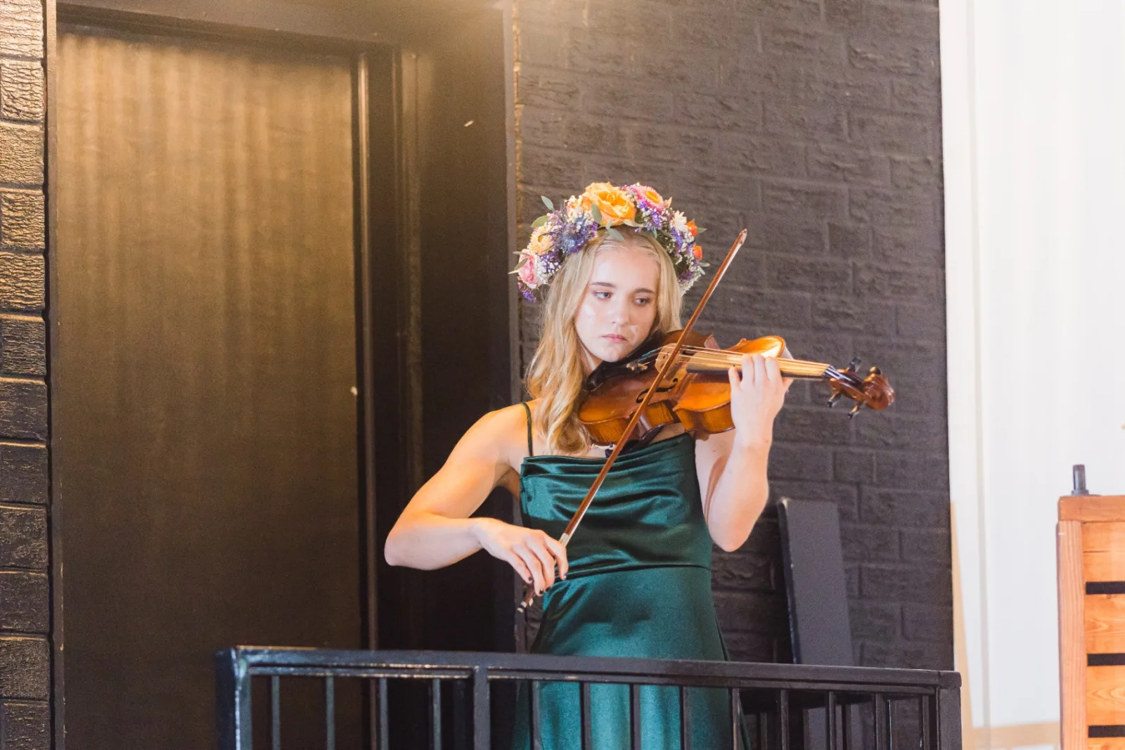 Violinist performing in emerald dress