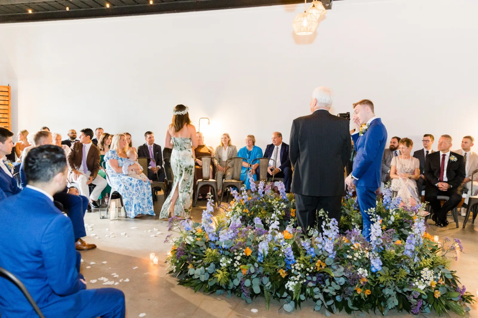 Ceremony with floral installation and guests seated in the round