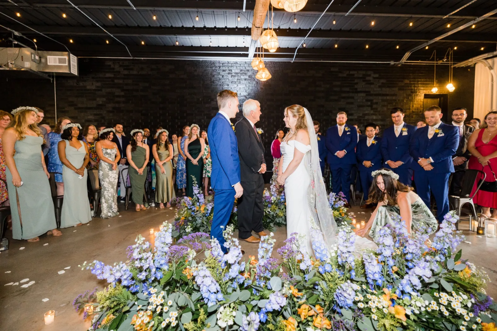 Bride and groom at the altar surrounded by flowers
