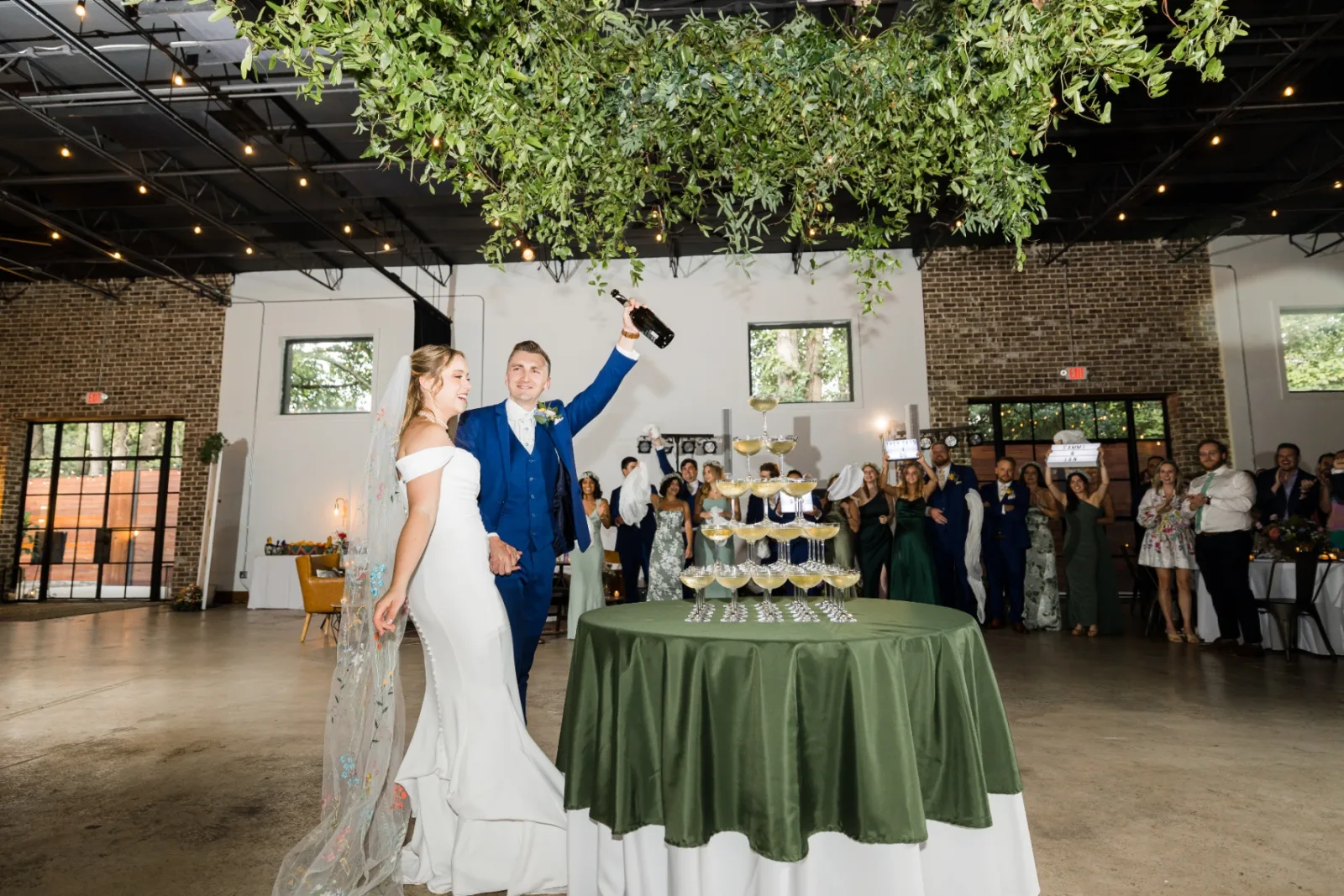 Bride and groom toasting at the champagne tower